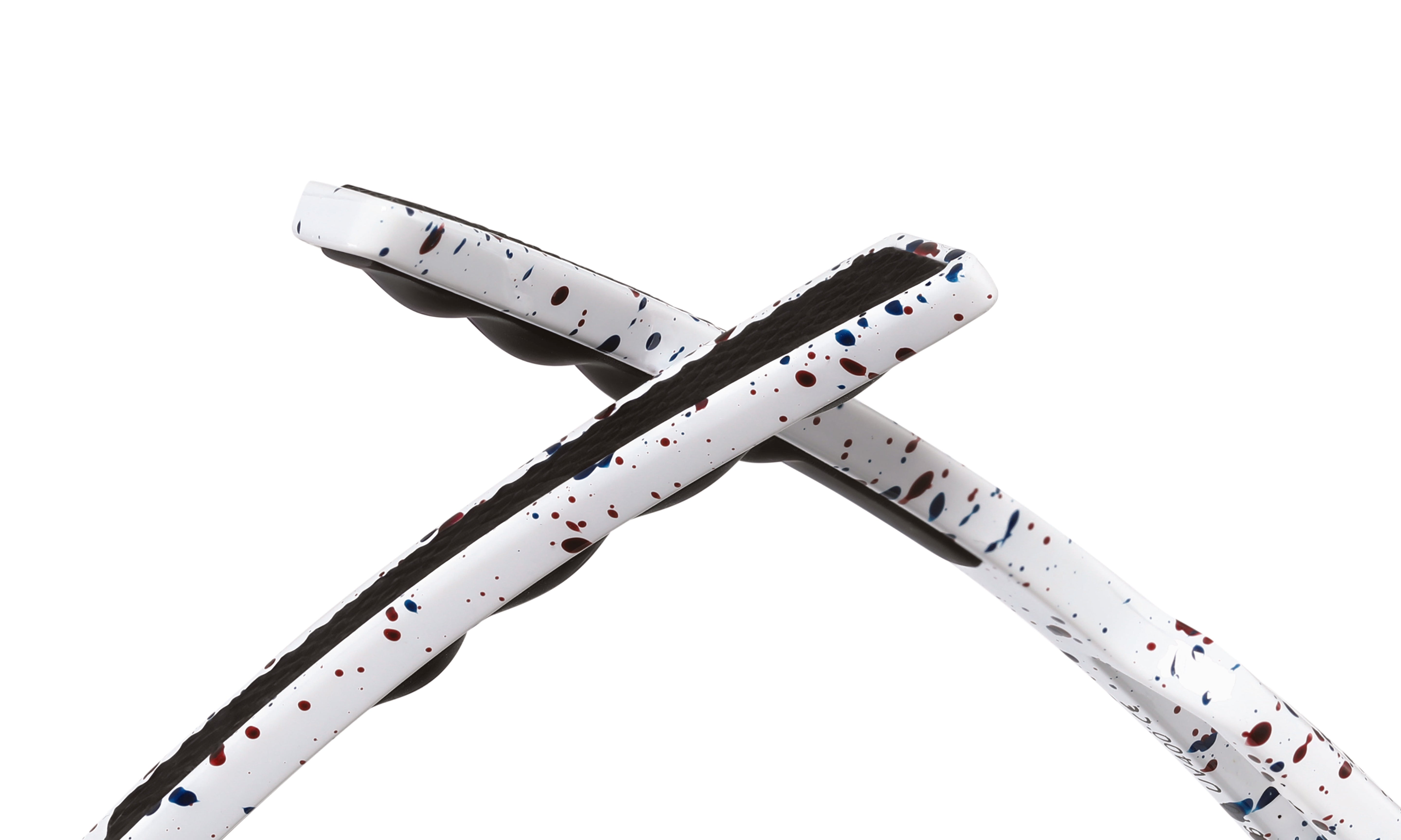 Close-up of white cycling sunglasses arms with red and blue splatter design and black grip.
