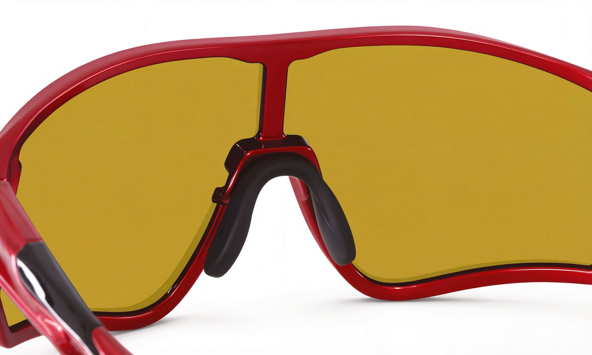 Close-up of red cycling sunglasses with yellow wraparound lens and black nose pads