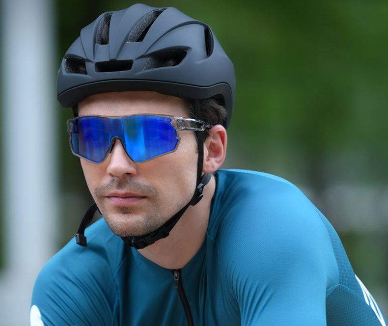 Man wearing blue mirrored cycling sunglasses and black helmet riding outdoors