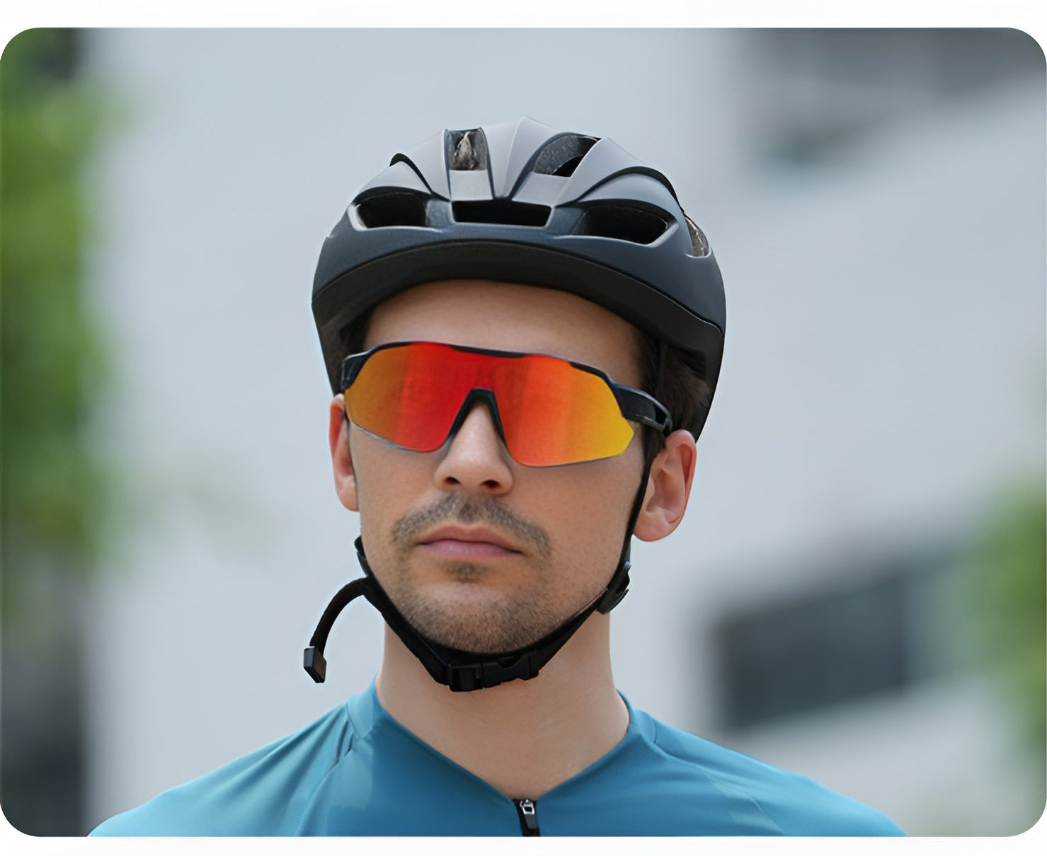 Man wearing red mirrored cycling sunglasses and bike helmet outdoors