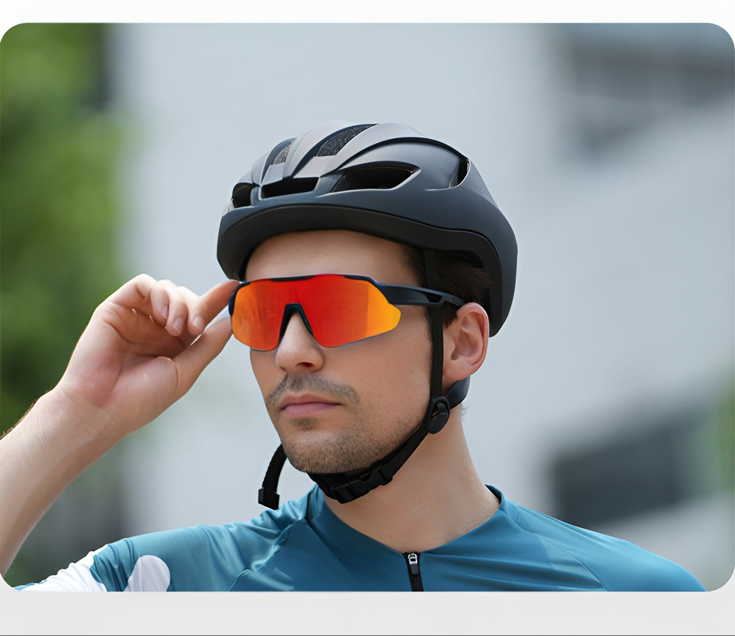 Cyclist wearing red mirrored prescription cycling sunglasses and a black helmet outdoors