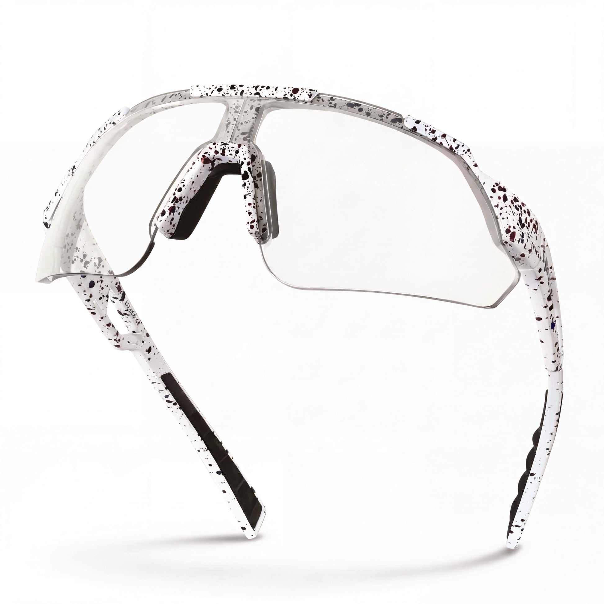 Clear lens cycling sunglasses with white and black splatter frame, side profile view