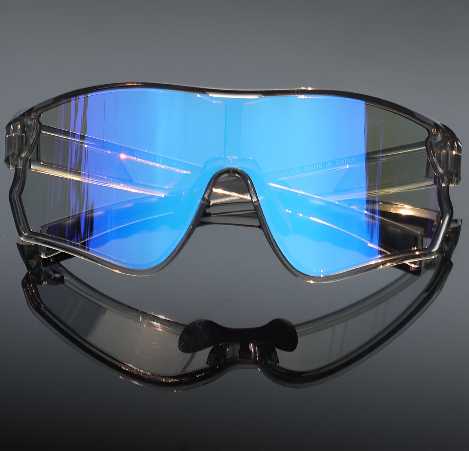 Blue mirrored cycling sunglasses with wraparound shield lens and black frame on reflective surface