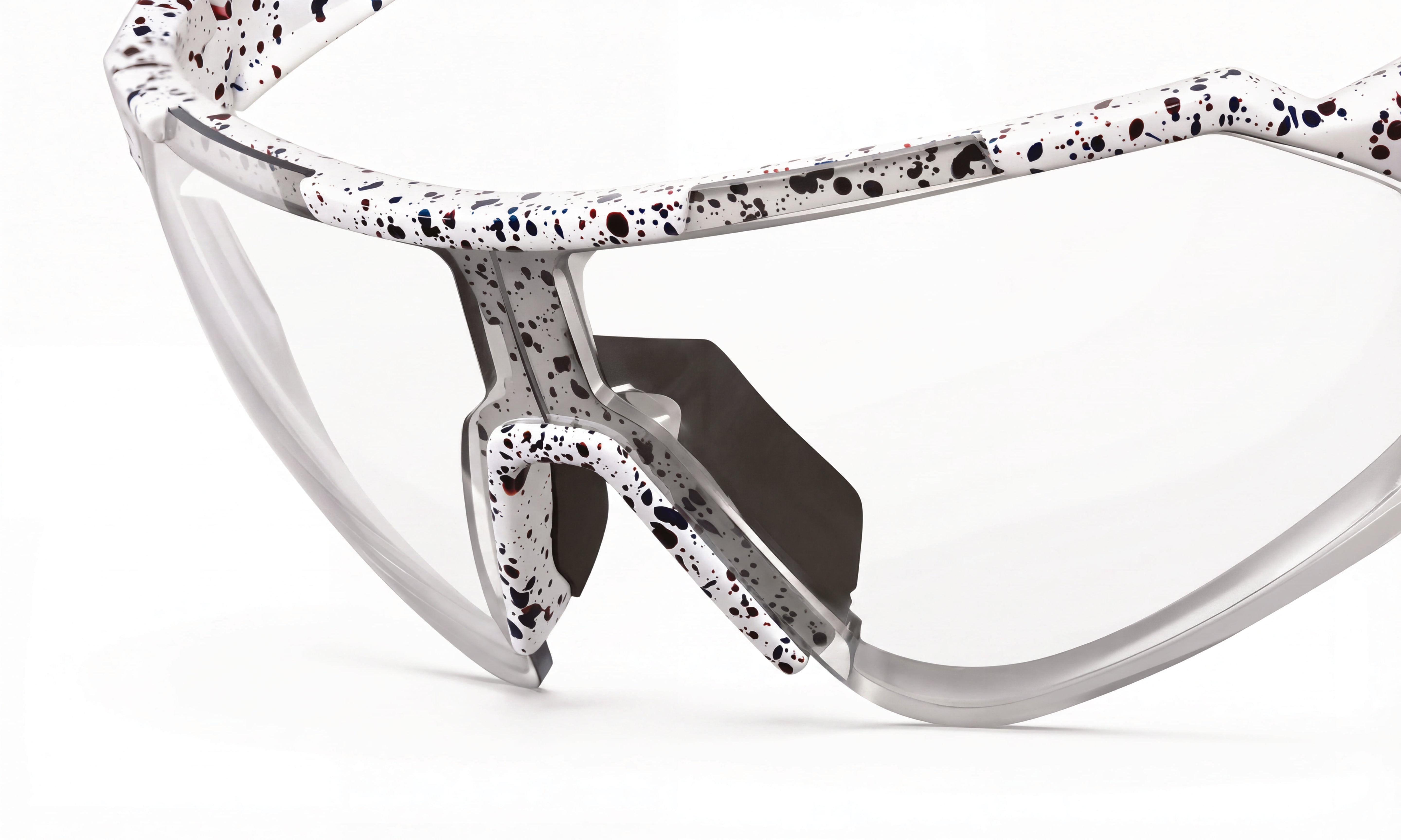 Clear lens cycling sunglasses with white and black speckled frame, close-up view