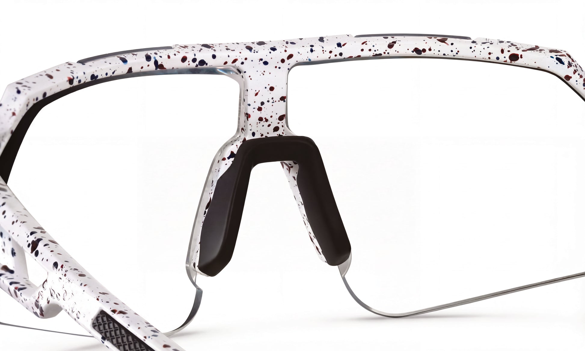 Close-up of white speckled cycling sunglasses frame with black nose pads, no lenses
