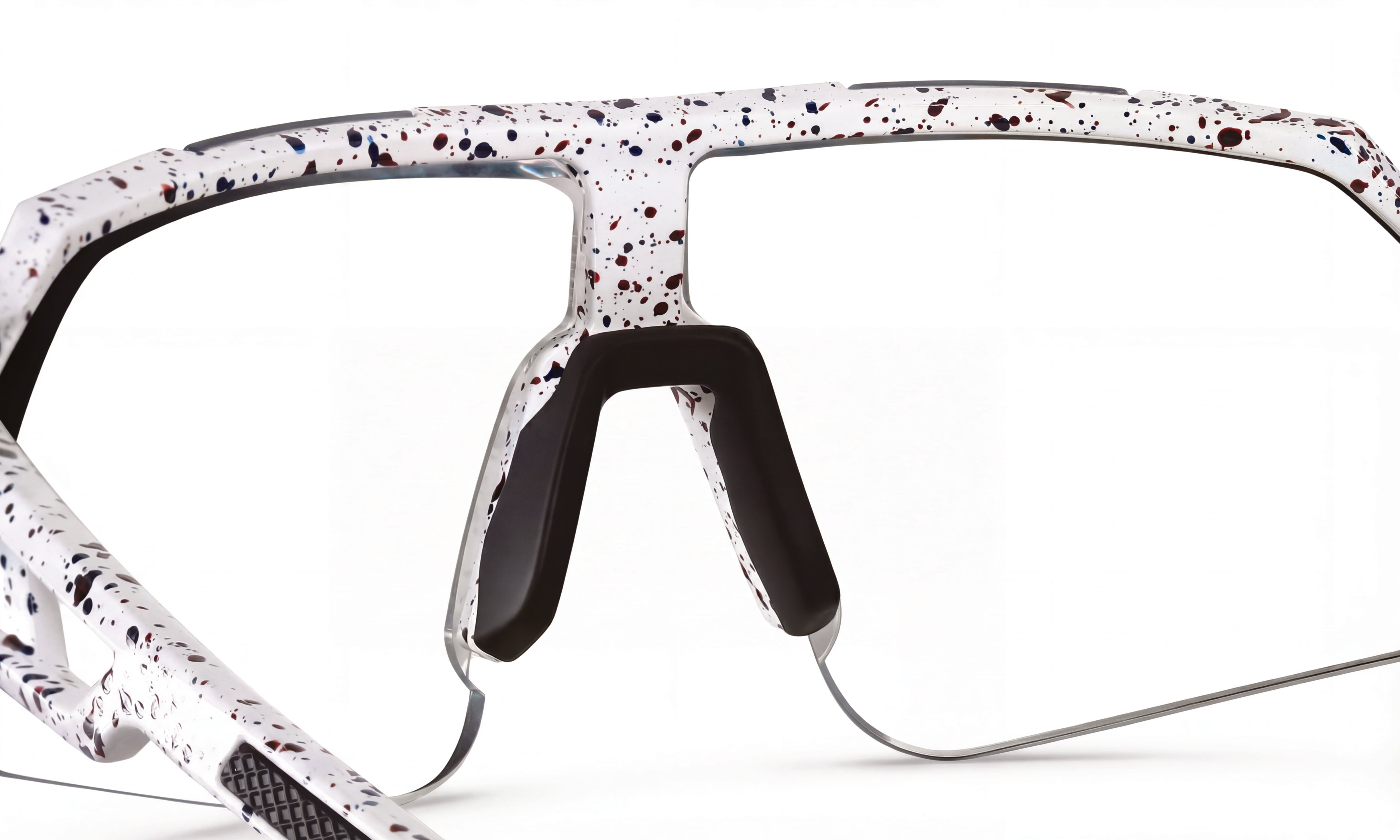 Close-up of white speckled cycling sunglasses frame with black nose pads, no lenses