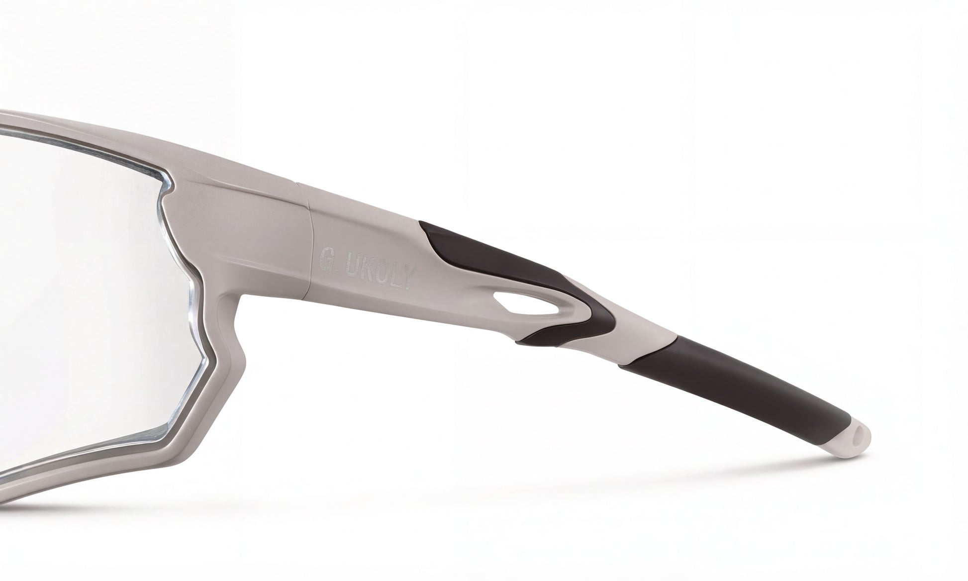 Close-up of a gray and black cycling sunglasses frame with clear RX lens on white background