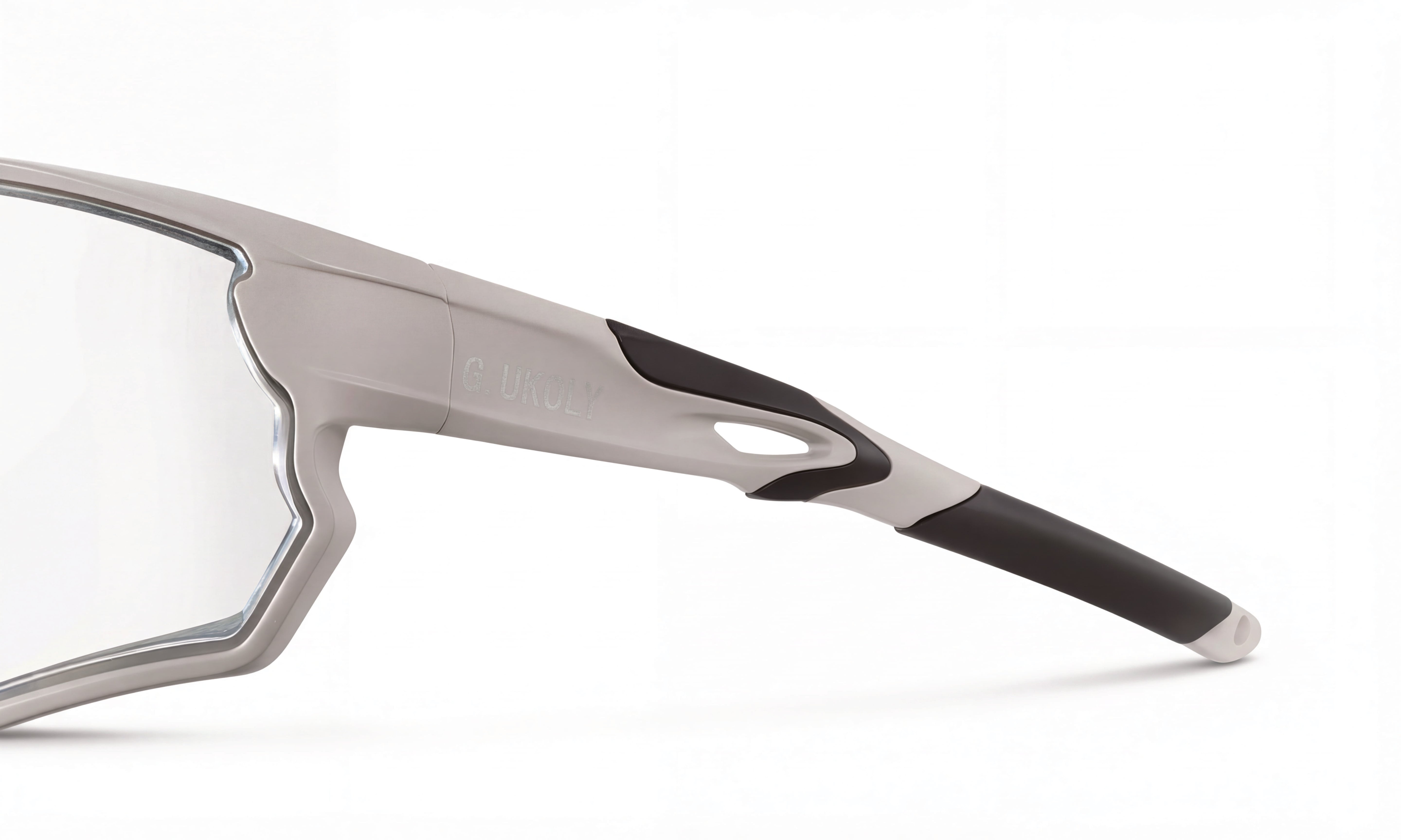 Close-up of a gray and black cycling sunglasses frame with clear RX lens on white background